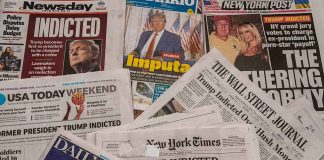 Newspaper headlines about Trump indictment and charges.