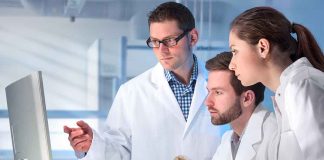 Scientists analyzing data in a laboratory setting.