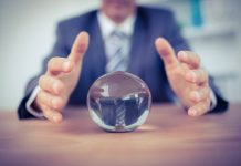 Man in suit reaching for crystal ball