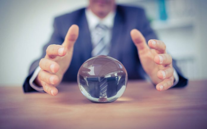 Man in suit reaching for crystal ball