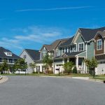 Suburban street with colorful, modern houses.