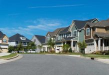 Suburban street with colorful, modern houses.