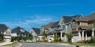 Suburban street with colorful, modern houses.