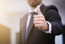 Person in suit giving thumbs up