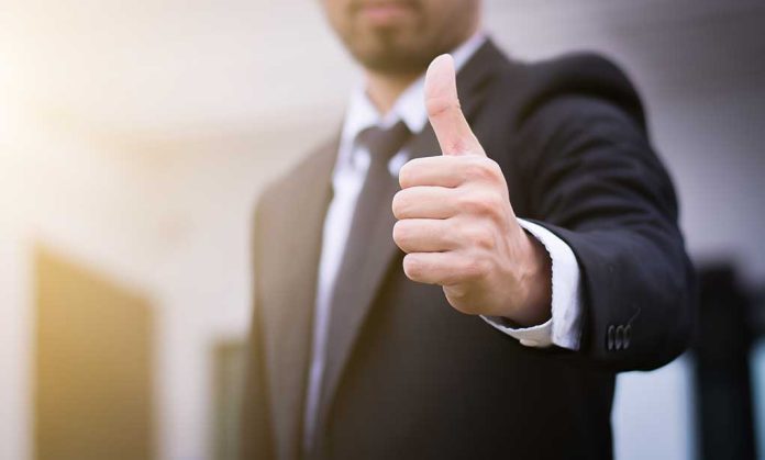 Person in suit giving thumbs up