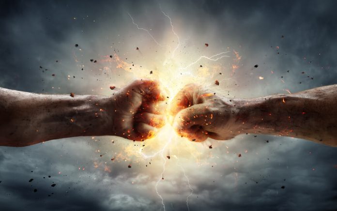 Two fists colliding with sparks and debris