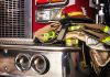 Firefighter gear on a fire truck bumper.