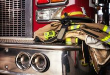 Firefighter gear on a fire truck bumper.