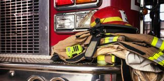 Firefighter gear on a fire truck bumper.