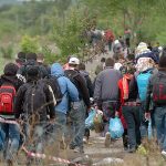 Group of people walking on a rural path