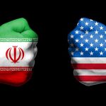 Two fists painted with Iran and USA flags