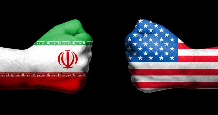 Two fists painted with Iran and USA flags