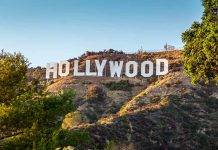 Hollywood sign on a hill with trees.