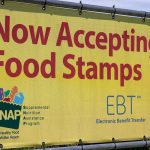 Yellow sign now accepting food stamps EBT SNAP