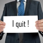 Person holding a sign saying I quit