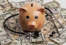 Piggy bank with stethoscope on dollar bills