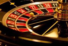 Close-up of roulette wheel with spinning ball.