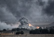 Smoke and fire rise from explosion in city landscape