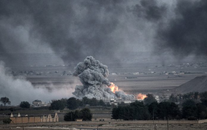 Smoke and fire rise from explosion in city landscape