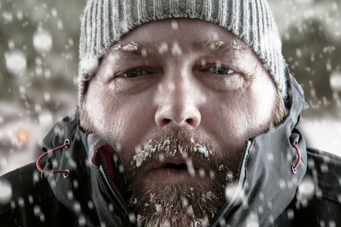 Man in snow with beard and knit hat